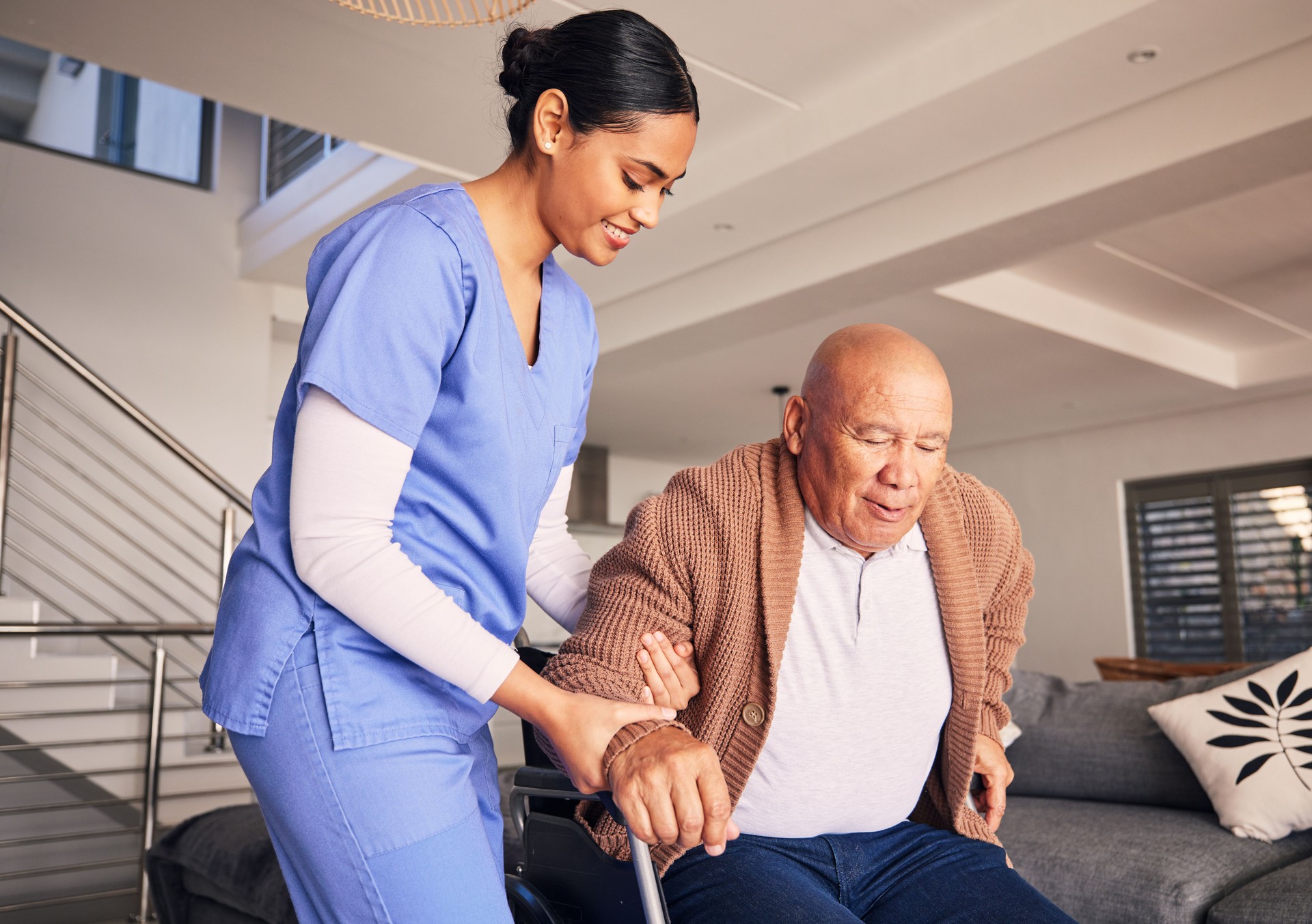 Happy woman, man in wheelchair and support in nursing home for medical service, physical therapy and retirement. Caregiver, nurse and helping patient with disability, homecare and health assistance