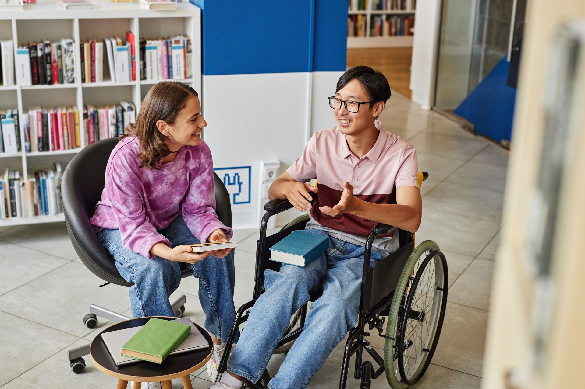 Young Student with Disability in College Library