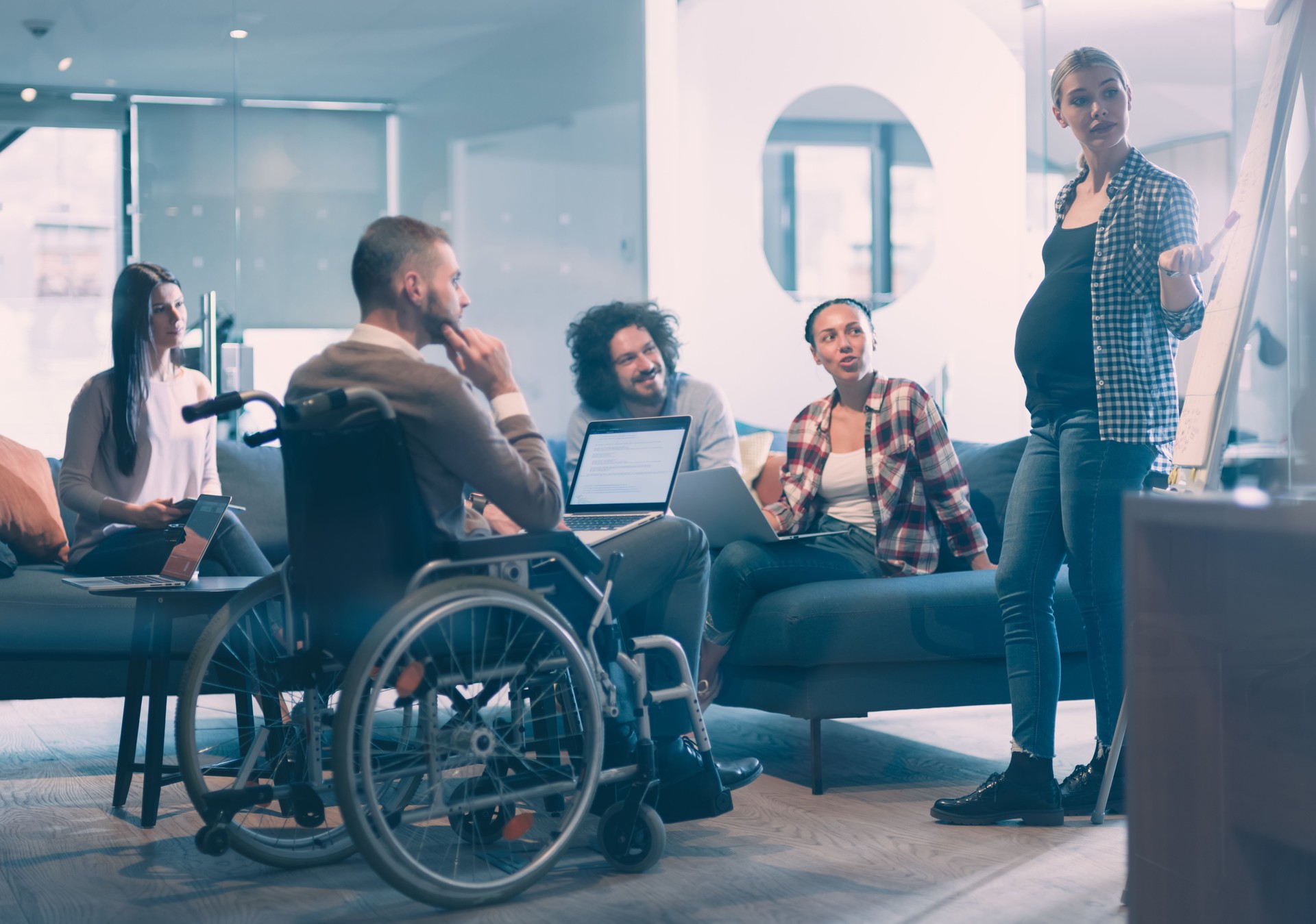 Pregnant Businesswoman Leads Creative Meeting Of Business Team In Modern Coworking open Space Office