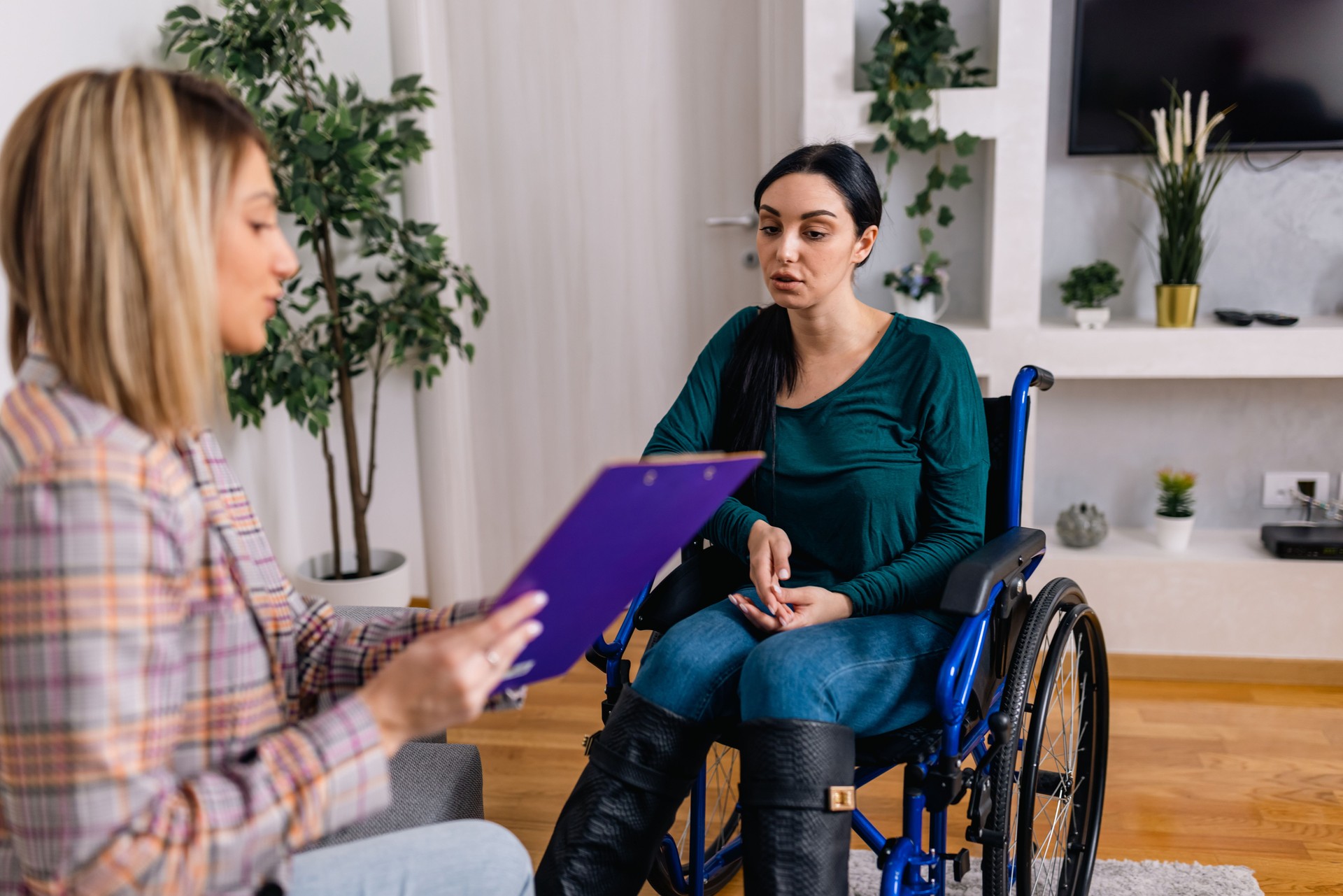 Young woman in a wheelchair finds strength through therapy with her compassionate psychotherapist