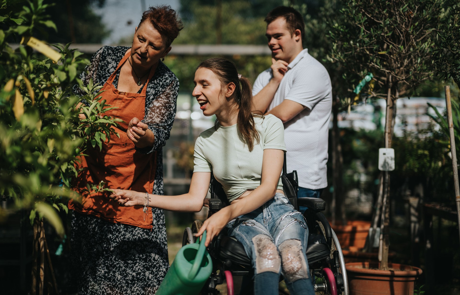 Disabled individuals enjoying gardening and nature together outdoors